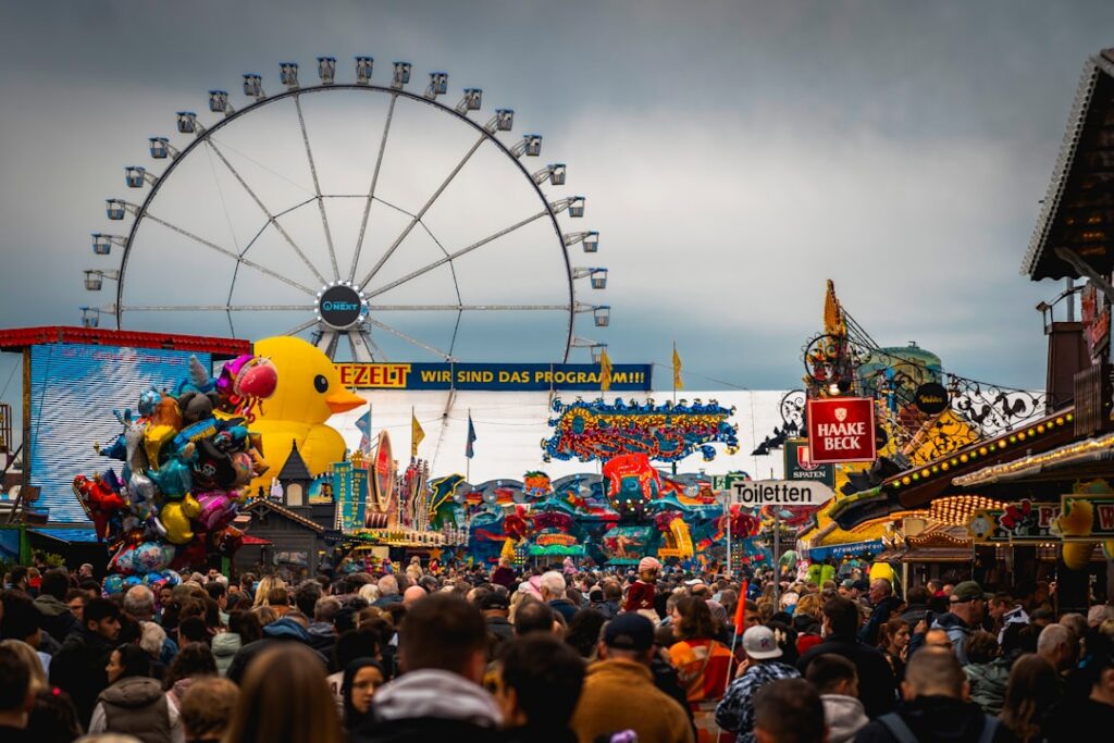 A crowd of people standing around a carnival
