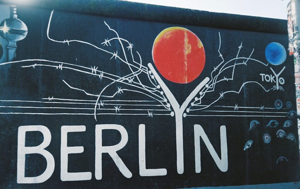 Berlin wall graffiti with "berlin" text and abstract art