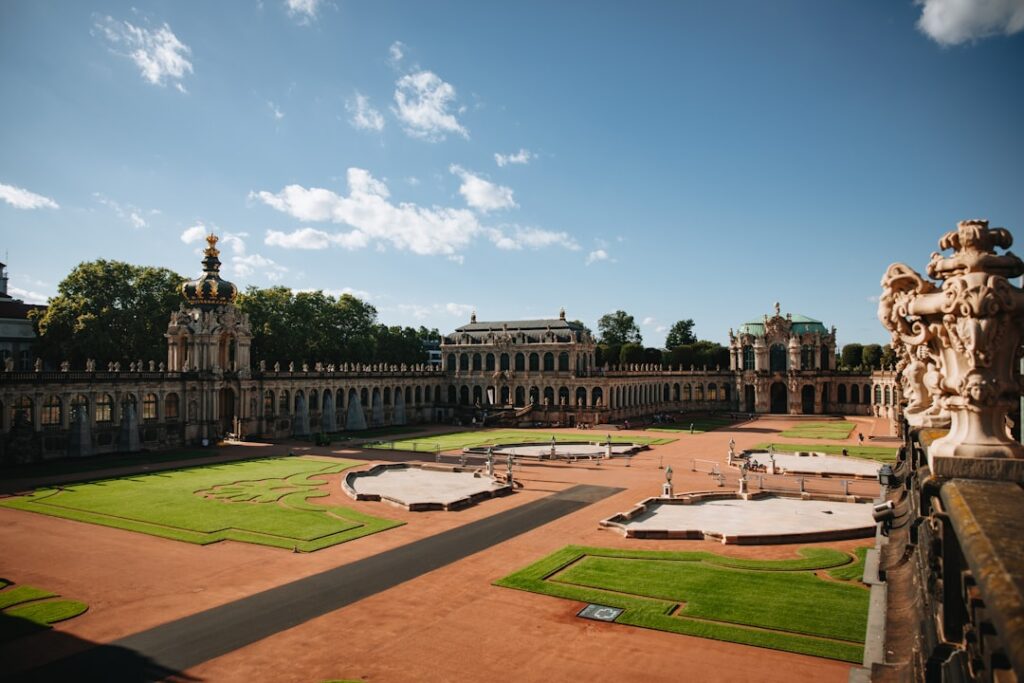 Grand courtyard of a historic palace with manicured lawns