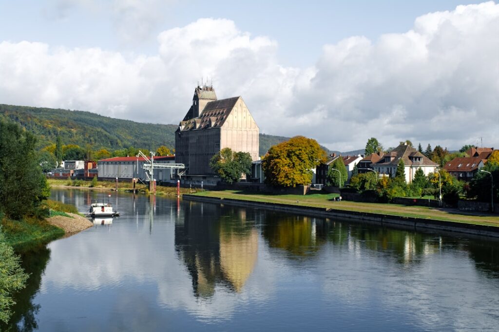Waterfront buildings reflect in a calm river