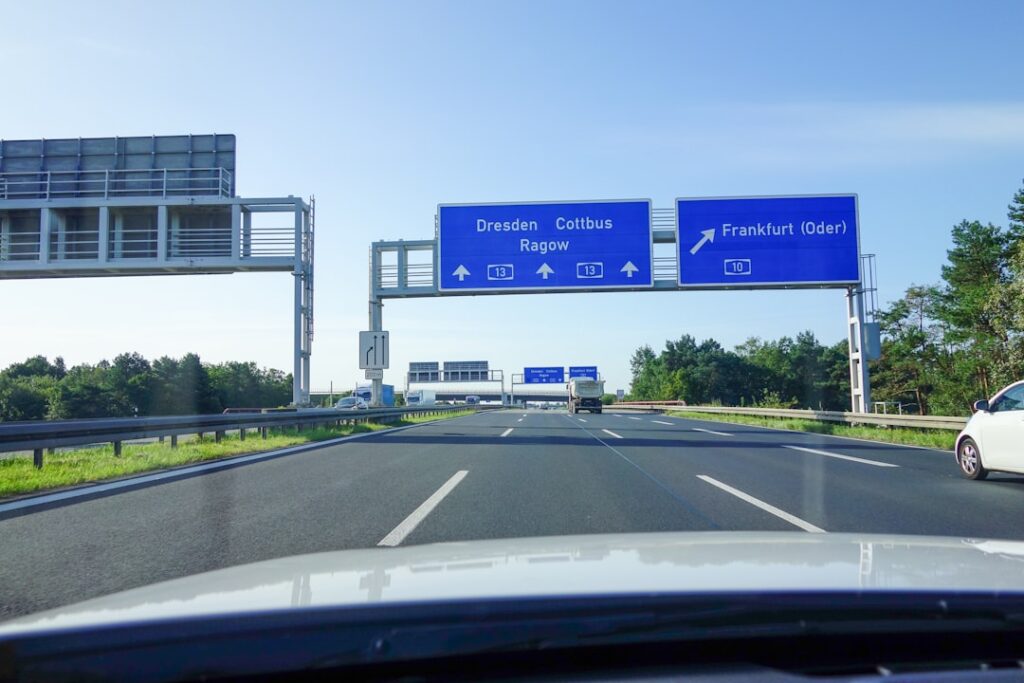 Highway view from car with blue overhead directional signs